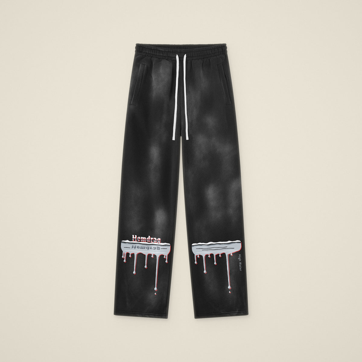 Digital preview: the High Water sweatpants laid flat, front view, with the chrome flood line and drips across both lower legs. The print was added digitally to a photo of the blank pants.