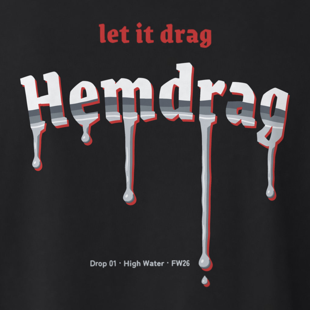 Digital preview: close-up of the whole back print on black cotton jersey: "let it drag" in red, the chrome Hemdrag letters with a red offset and every drip, and the line "Drop 01 · High Water · FW26". The ink and knit texture are simulated, not photographed.