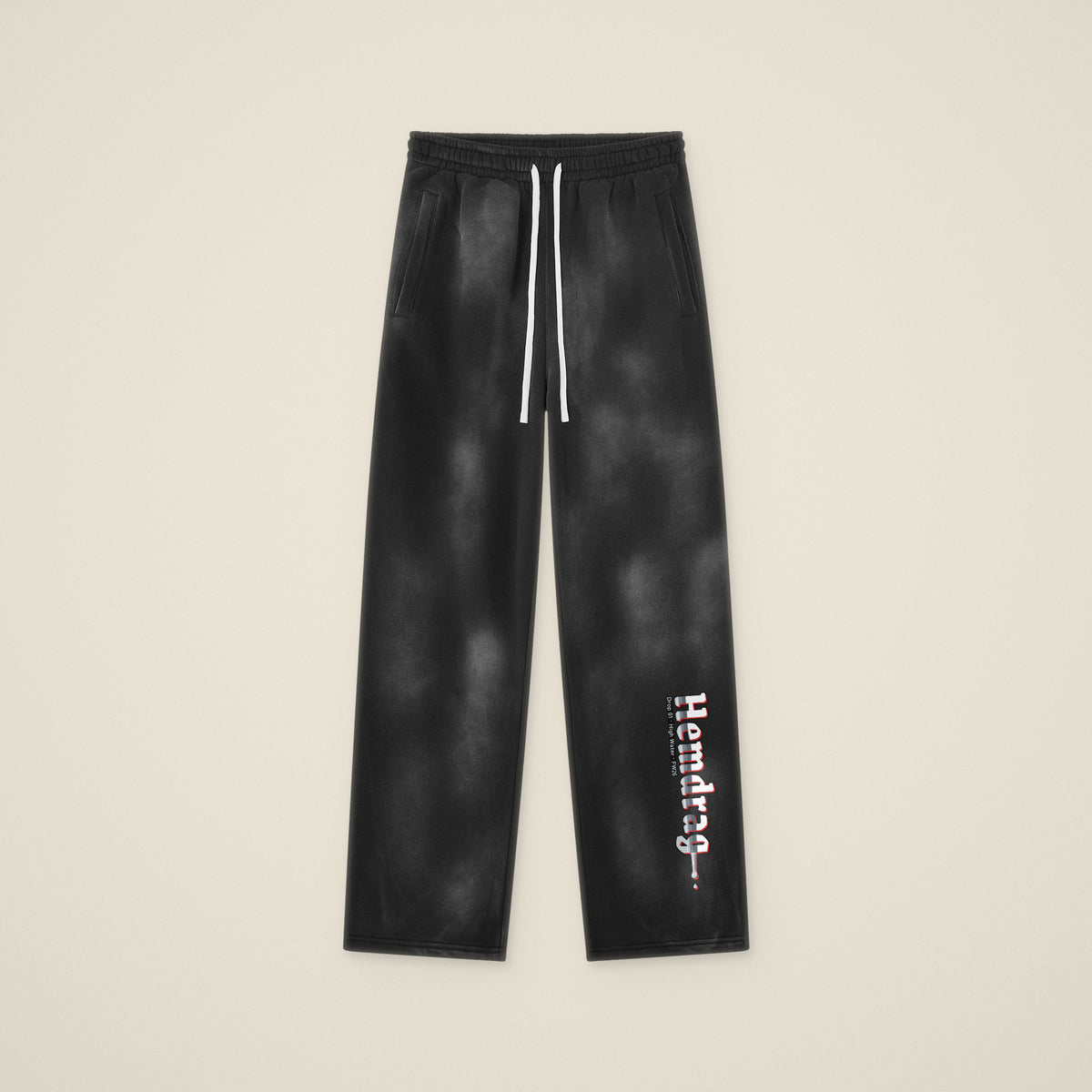 Digital preview: the Hemdrag sweatpants laid flat, front view, with Hemdrag printed down the left lower leg only. The print was added digitally to a photo of the blank pants.