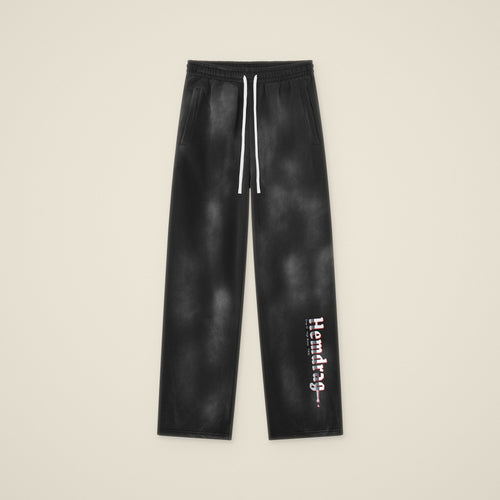Digital preview: the Hemdrag sweatpants laid flat, front view, with Hemdrag printed down the left lower leg only. The print was added digitally to a photo of the blank pants.